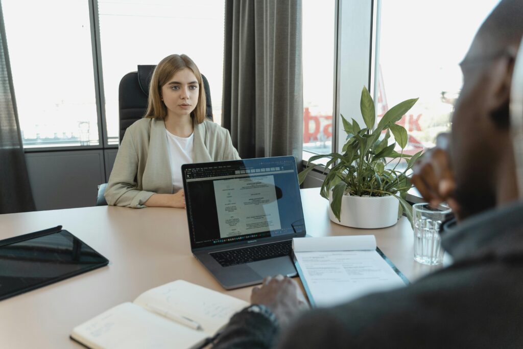 A woman sitting infront of a man during an interview